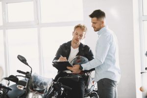 Man choosed motorcycles in moto shop.