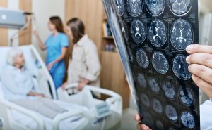 MRI of head of elderly woman in hands of doctor.