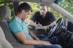 Shot of a traffic cop talking to a young driver