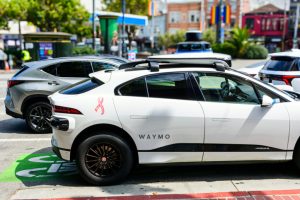 A white Waymo driver-less Jaguar I-PACE