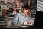 Detective working at desk in her office