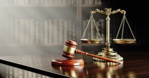 Scales of justice and and the judge's gavel hammer as a symbol of law and order.