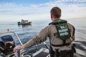 Warroad, Minnesota, USA - June 19 2018: U.S. Border Patrol agent on a boat in the water