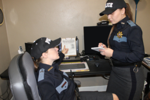 two female police officers in uniform checking things out