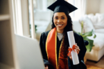 Happy student showing her graduation diploma and looking at camera.