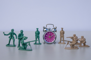 armies confront against the backdrop of an alarm clock