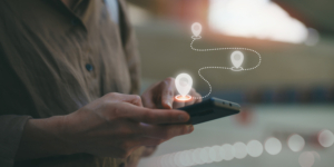 Female hand using smartphone GPS navigator. Discovering new destinations. Navigate the streets and explore cityscapes with 5G. Technology, lifestyle, travel concept.