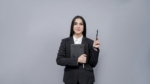 Young businesswomen holding book looking left wearing black coat