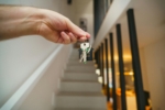 Holding keys in front of a staircase