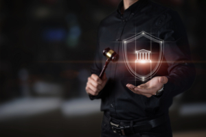 legal protection concept. Lawyer showing courthouse icon on blurred dark background.