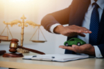 Judge gavel and miniature car symbolize auction or court case against driver who has accident and receiving vehicle insurance payment be on table in front of hands of lawyers. Selective focus