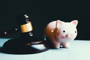 a gavel and a piggy bank, to represent the intersection of law and finance