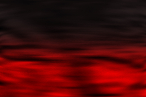 Deep red light flickering on the water surface against a black background (Color processed image illustration)
