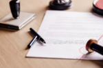 Notary pen lying on testament.