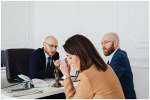 Discussion among lawyers and a client in an office setting