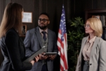 Diverse group of professionals in a formal office setting featuring an American flag and bookshelves