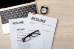 Resumes on laptop with glasses resume review, job interview