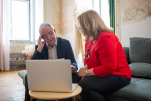 Individuals discussing financial planning topics, such as retirement security and estate planning, in a home office setting